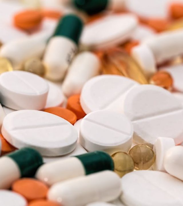 Close-up of various pills and capsules in different colors and sizes, ideal for healthcare-related content.